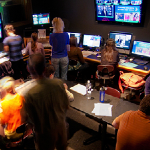 Photo of students in broadcast studio editing room