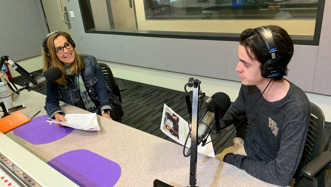 A mother and son work together on a podcast.