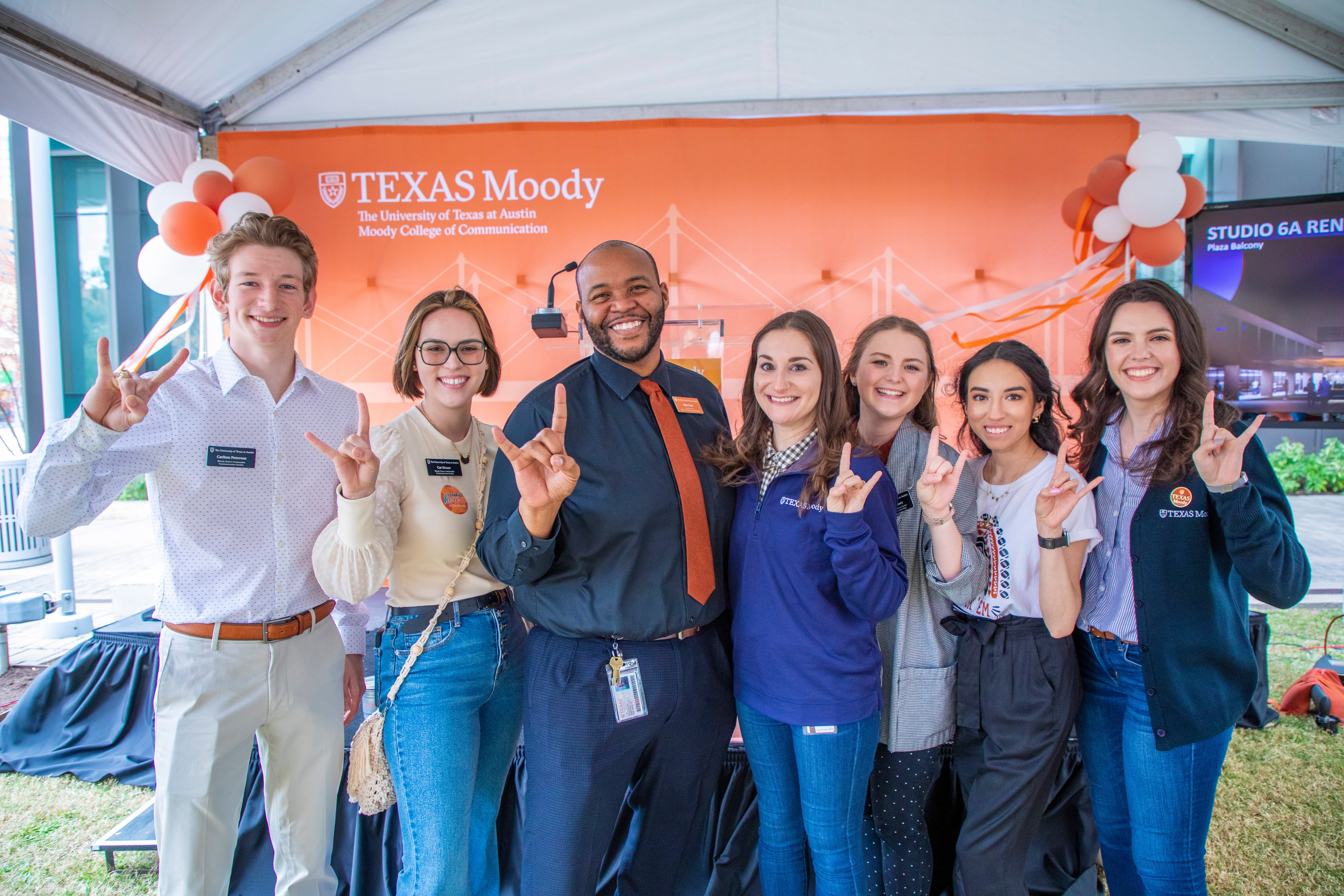 A group of college faculty and staff celebrate a new campaign.