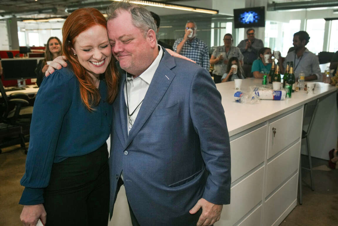 Lisa Falkenberg and Michael Lindenberger hug after being awarded the Pulitzer Prize in Opinion Writing.