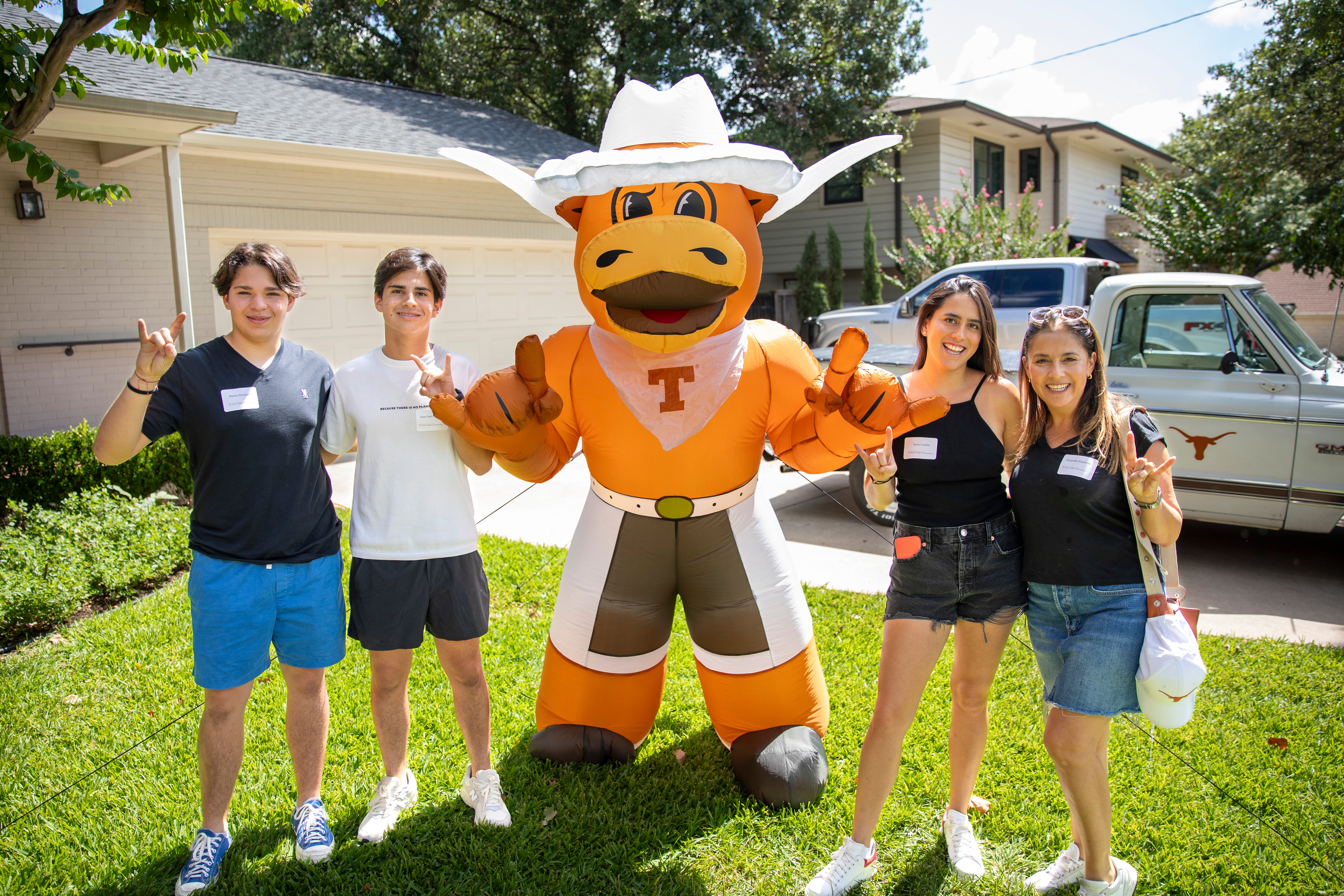 Students with blow up hook 'em in yard