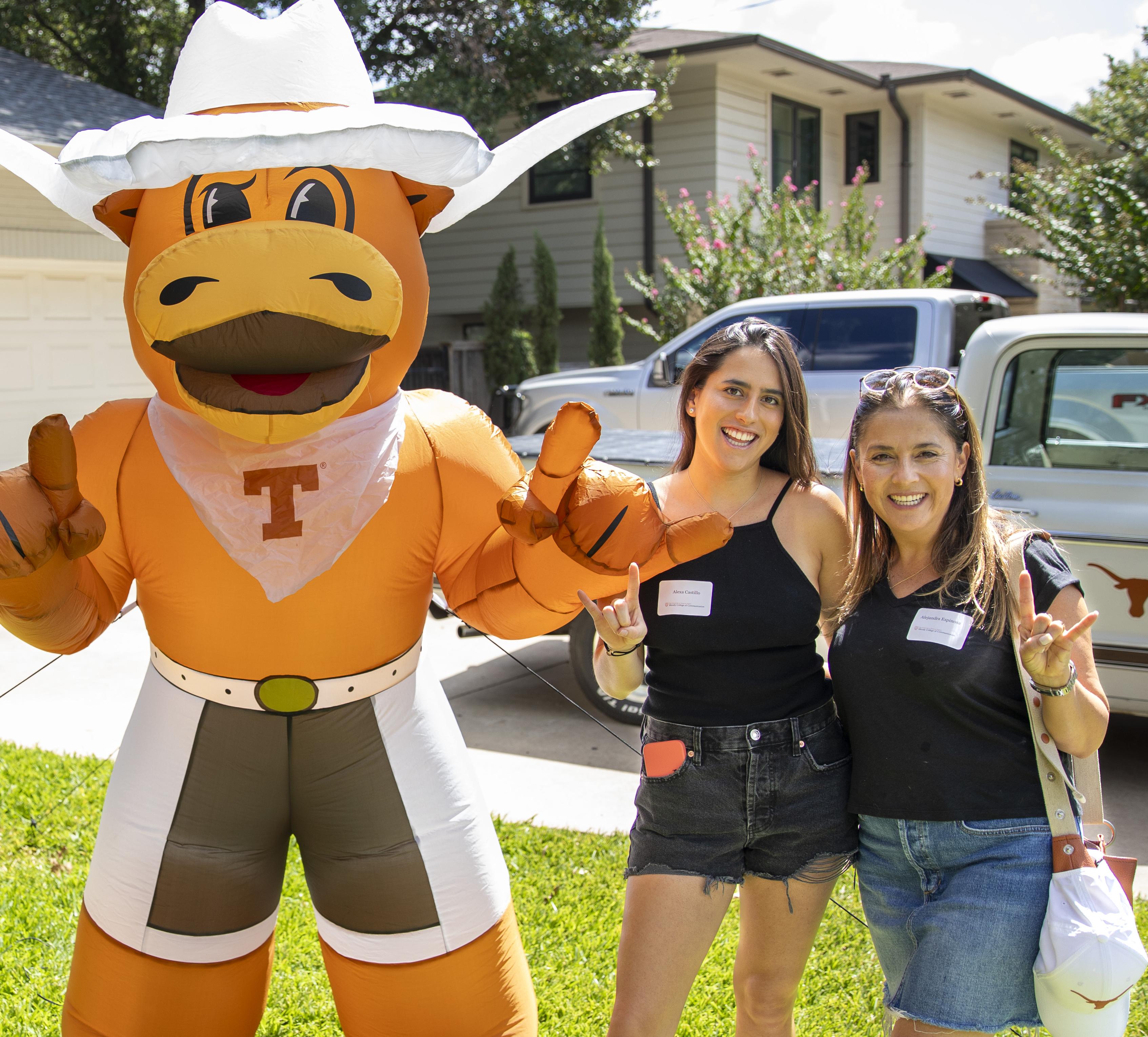 Students with blow up hook 'em in yard