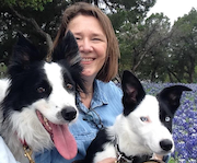 Mary Crawford outside with two black and white border collies