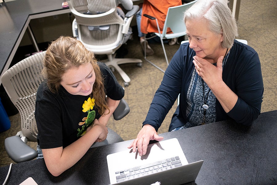 writing program director diana dawson working with student 