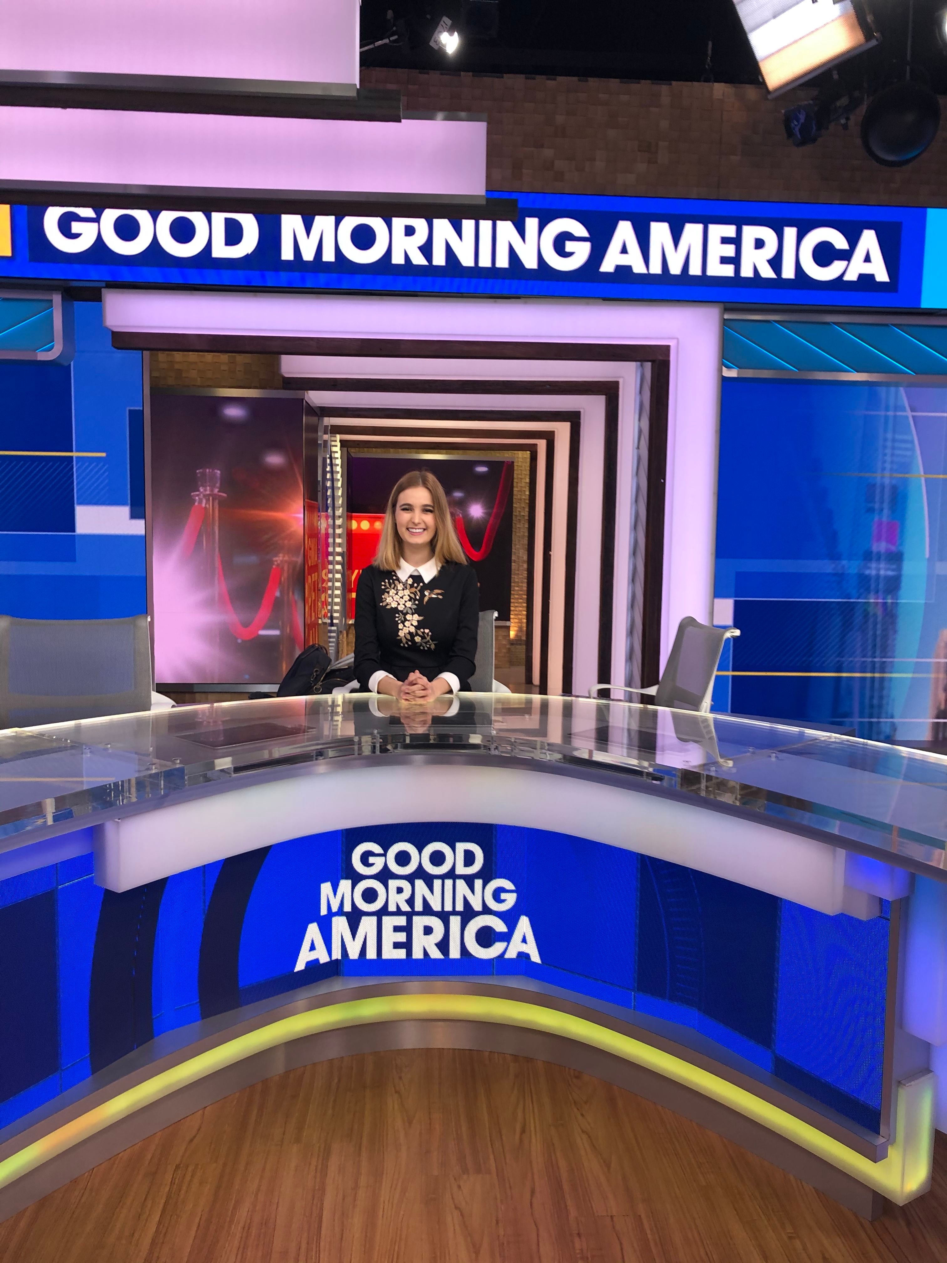 laura laughead sitting on a broadcast table in