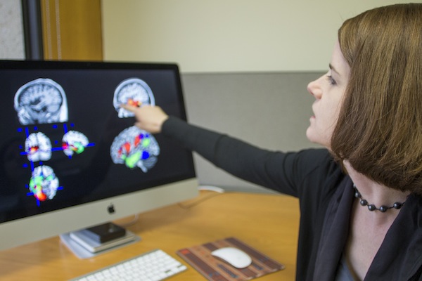 Maya L. Henry explains images of a brainscan. 