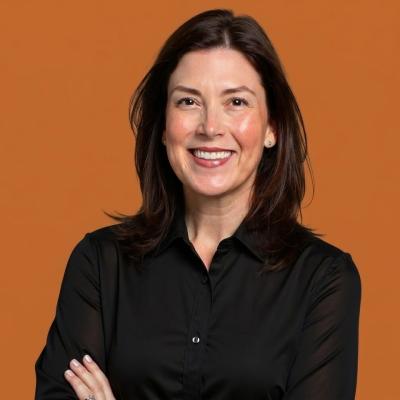 Headshot of Laura Bright against an orange backdrop