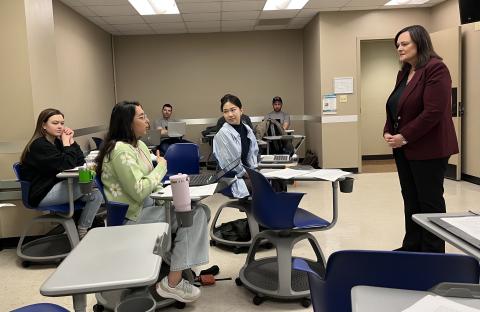 Dr. Stephens on the right side of the photo sharing tips with students seated on the left side of the photo