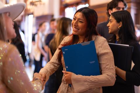 Student shaking hands at a career expo