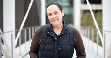 Journalism professor kate dawson standing on the moody bridge 