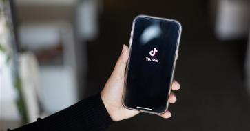 Photo of a phone with TikTok on the screen