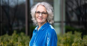 portrait of donna decesare in blue standing outside of DMC