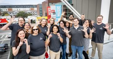 group photo of texas standard staff standing on the moody bridge celebrating 10 years