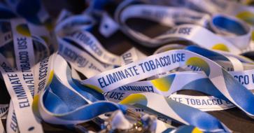 close up of lanyards with text that says eliminate tobacco use