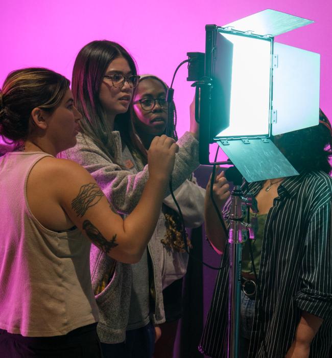 Students looking at film lighting