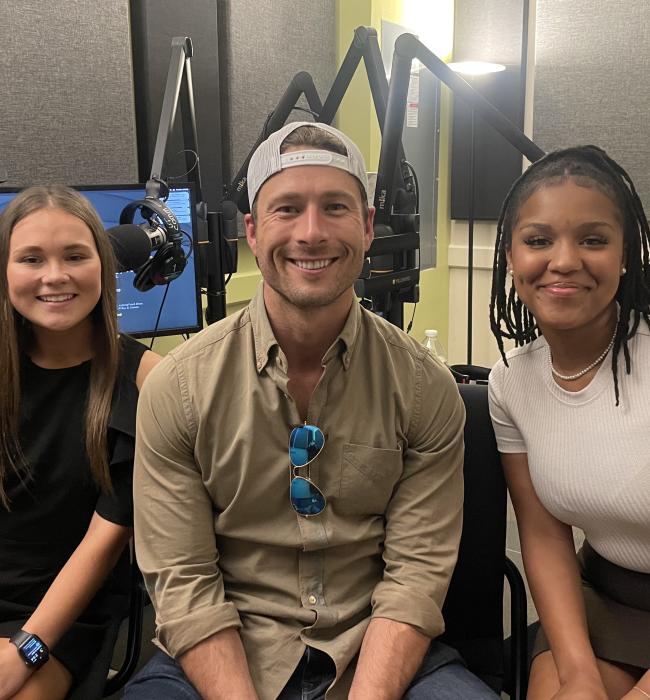 Glen Powell with students