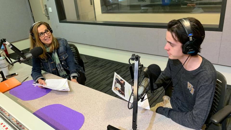 A mom and son work together in a recording studio.