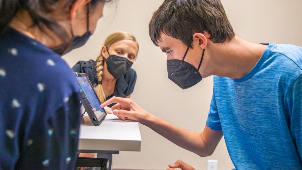 An SLHS student working with a patient