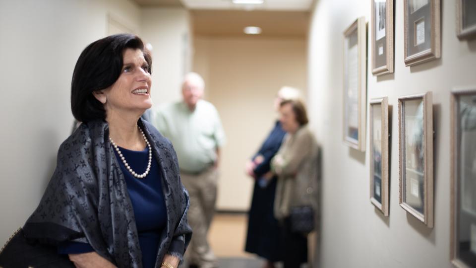 Luci Baines Johnson admires photos of her mother Lady Bird Johnson.
