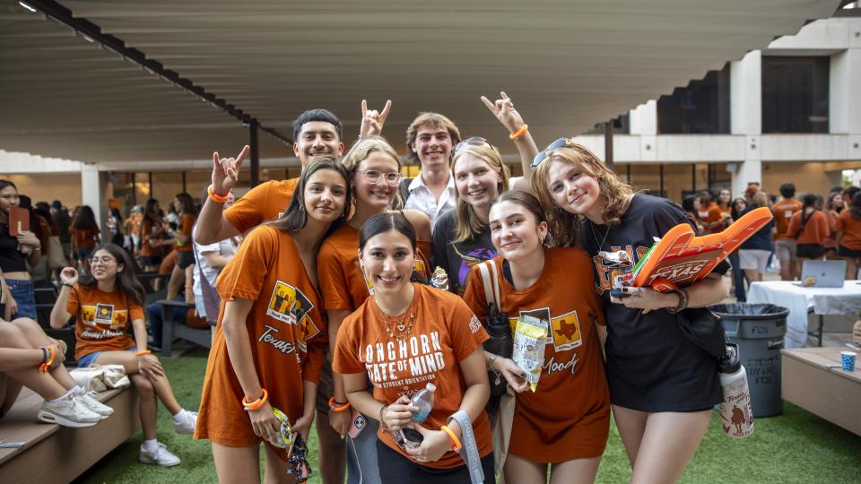 A group of Moody College students wearing burnt orange at the CommUnity event in August 2024.
