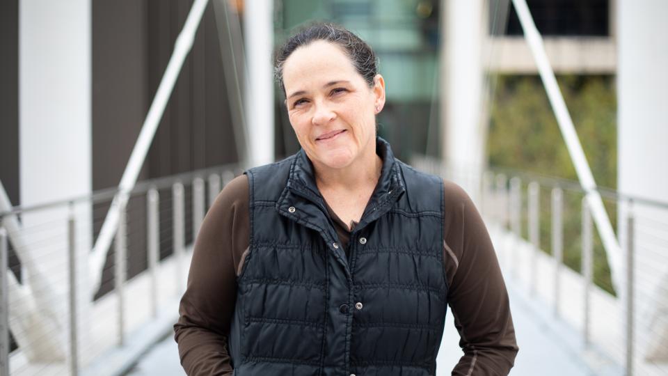 Journalism professor kate dawson standing on the moody bridge 