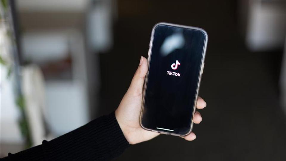 Photo of a phone with TikTok on the screen