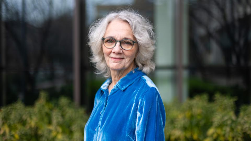 portrait of donna decesare in blue standing outside of DMC