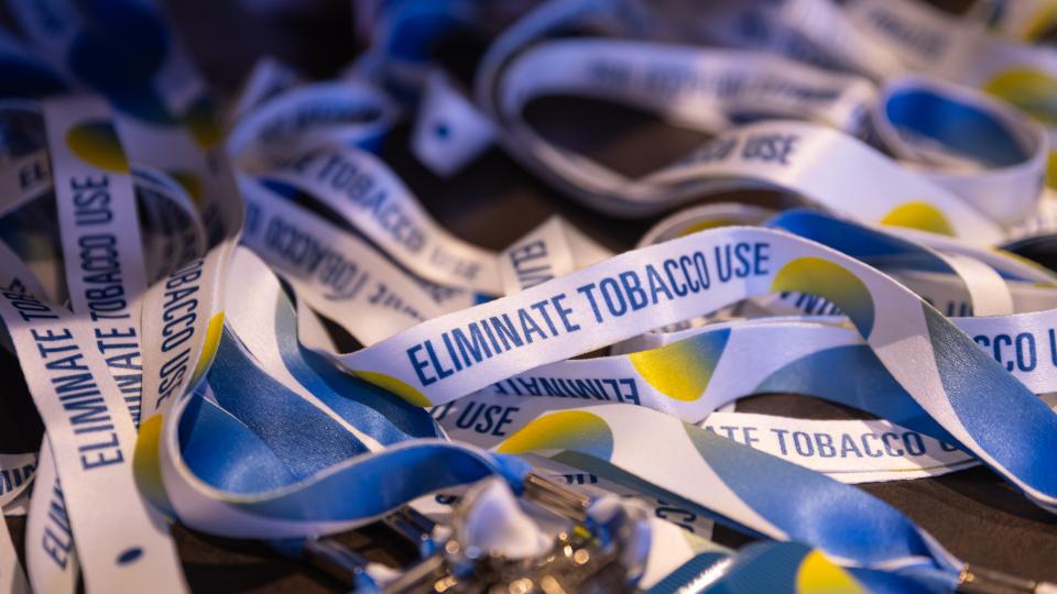 close up of lanyards with text that says eliminate tobacco use