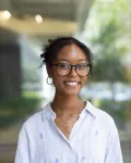 Portrait of a young woman wearing glasses.