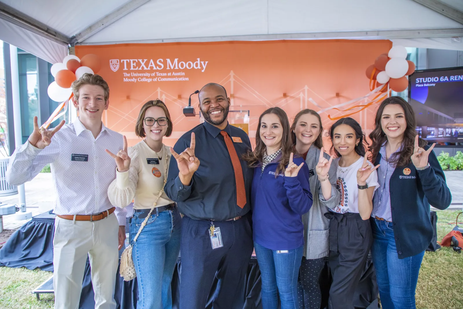 A group of college faculty and staff celebrate a new campaign.