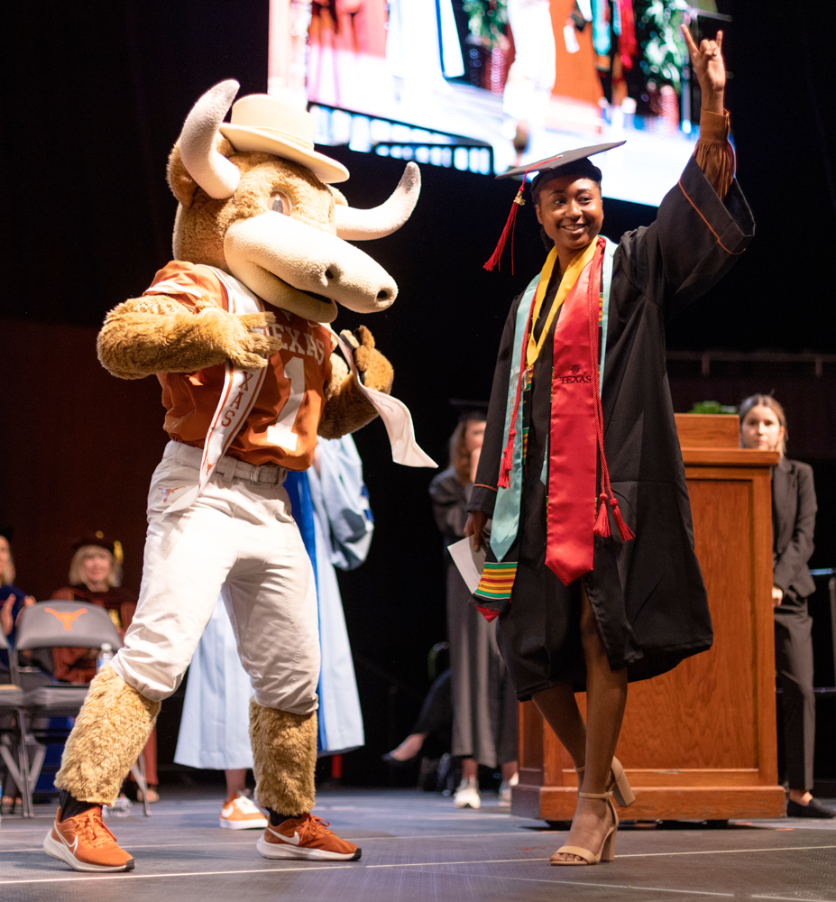 a moody graduate on stage getting their diploma