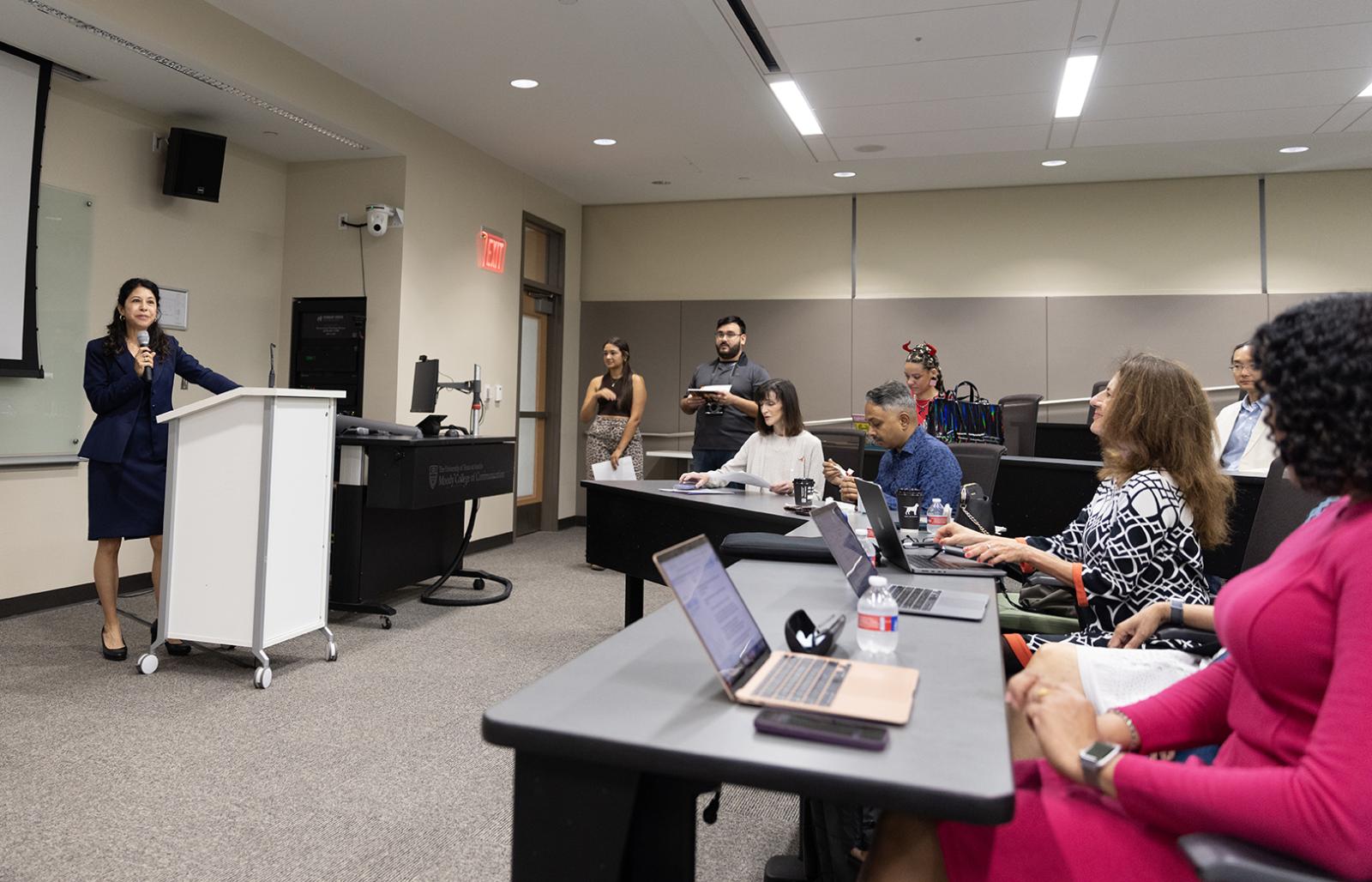 Celeste Gonzalez de Bustamante speaks to a room with attendees 