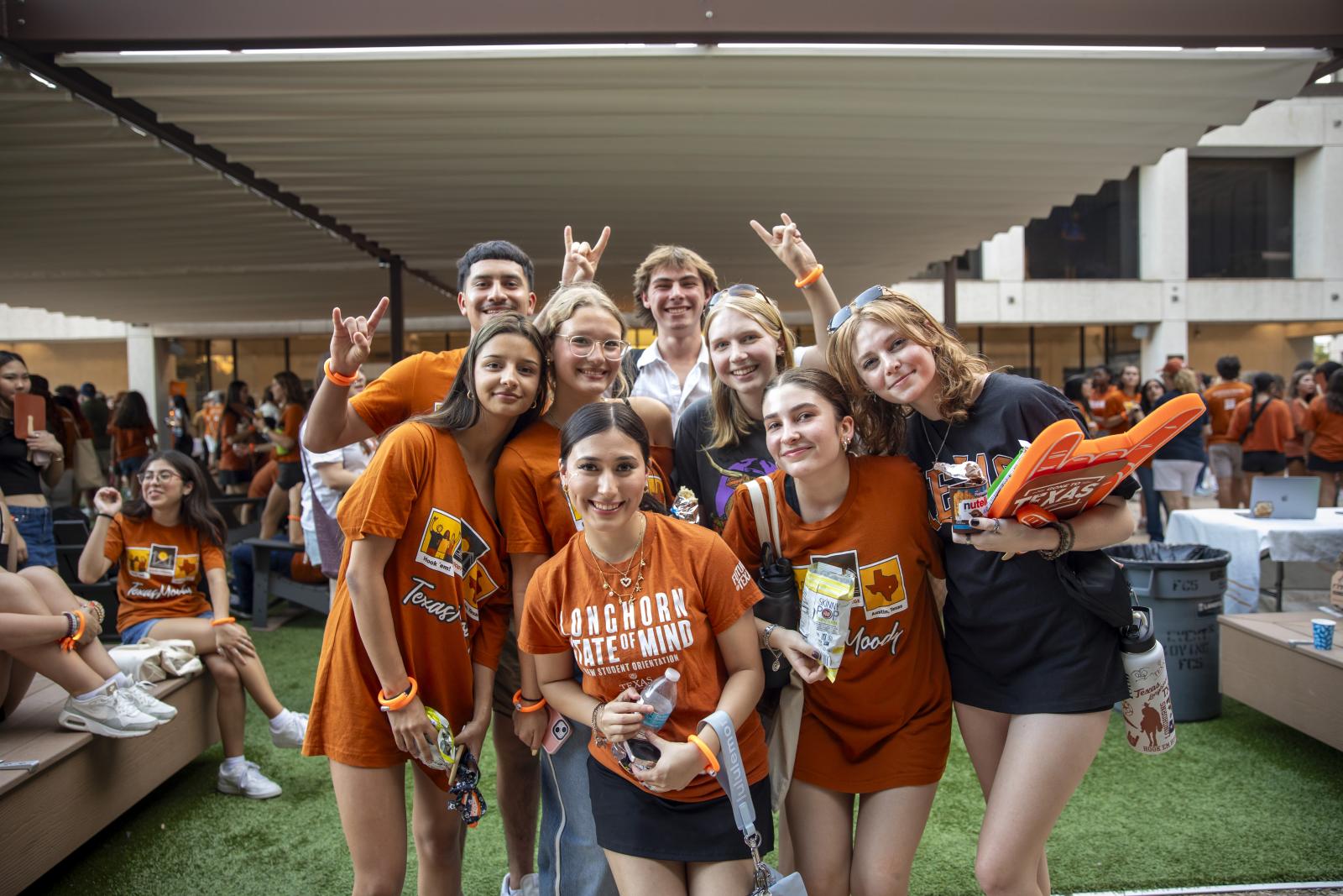 A group of Moody College students wearing burnt orange at the CommUnity event in August 2024.