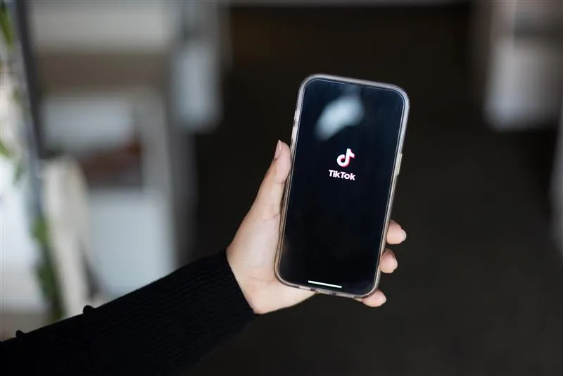 Photo of a phone with TikTok on the screen