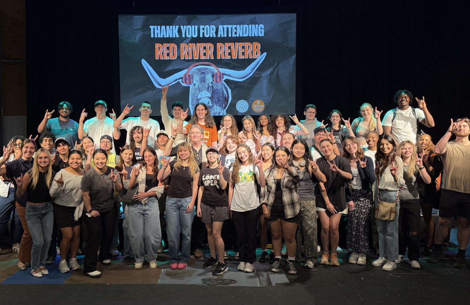 Red River Reverb Full Class A class of students hold up the Hook Em Horns hand sign