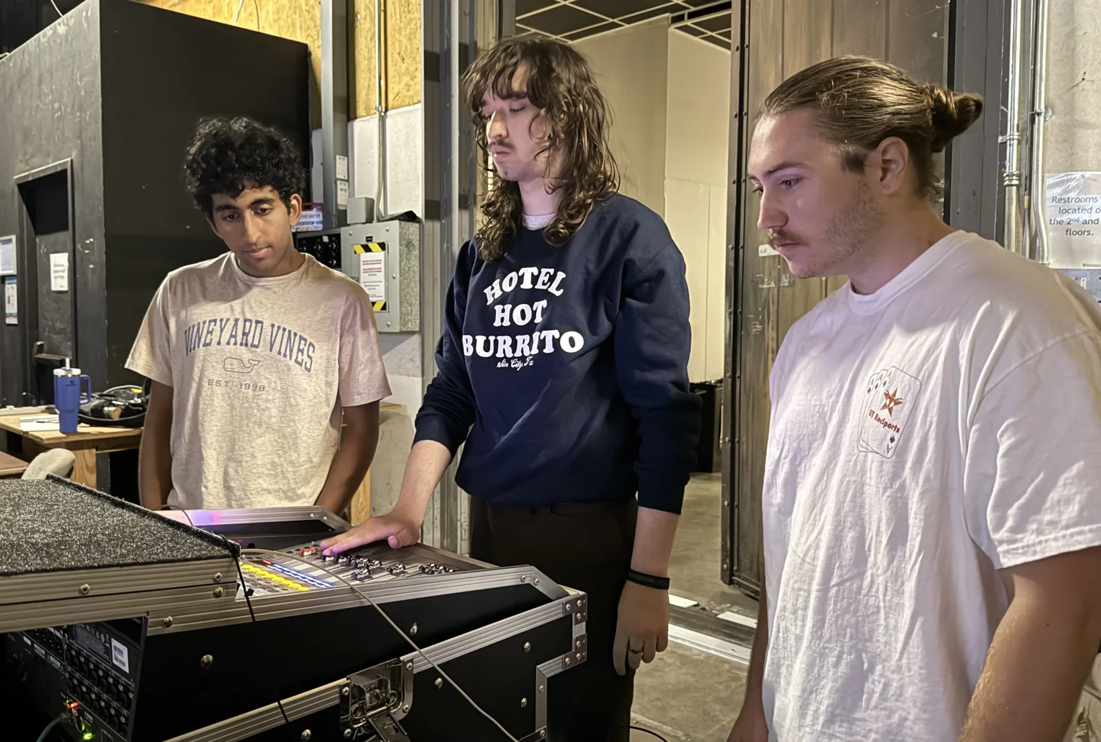 3 members of the sound team monitoring sound over a machine at Red River Reverb