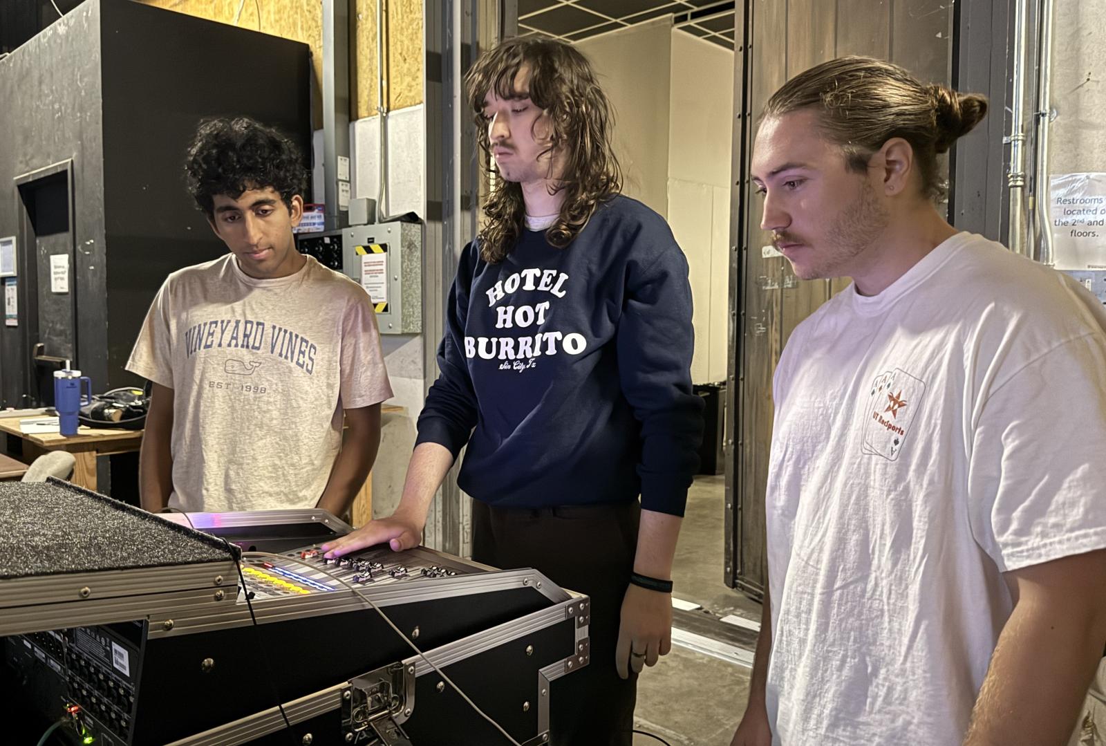 3 members of the sound team monitoring sound over a machine at Red River Reverb