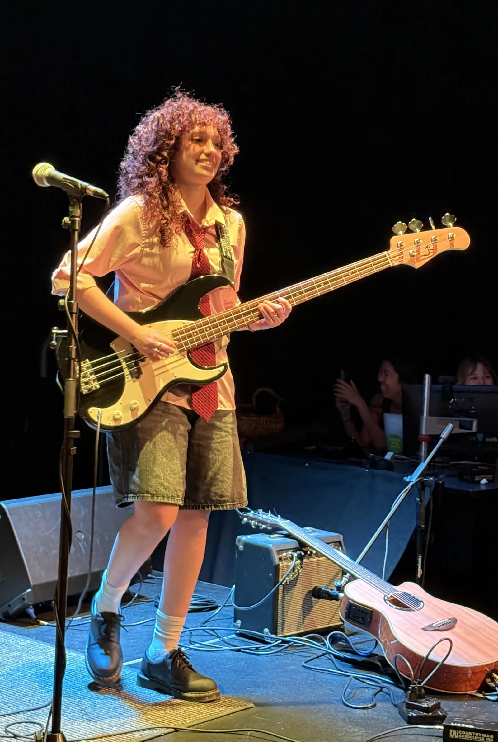 Guitarist for student band Late Registration Fees smiles at the crowd while performing at Red River Reverb