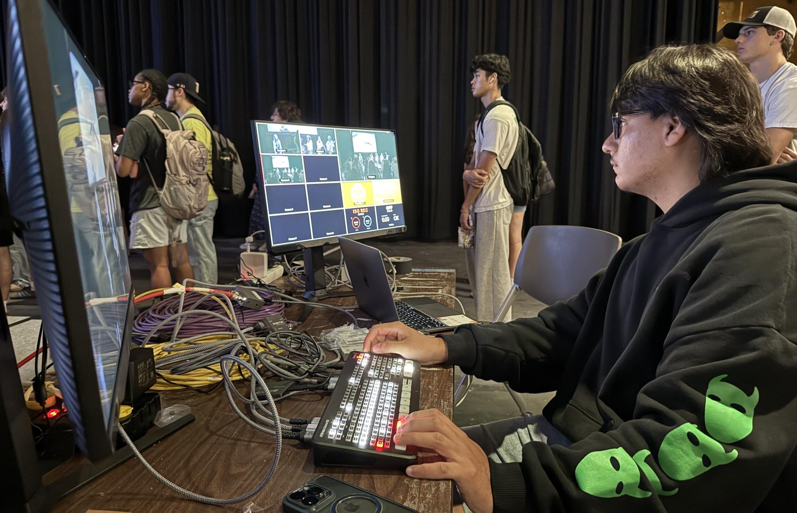 A person sits at a computer monitoring the production of Red River Reverb