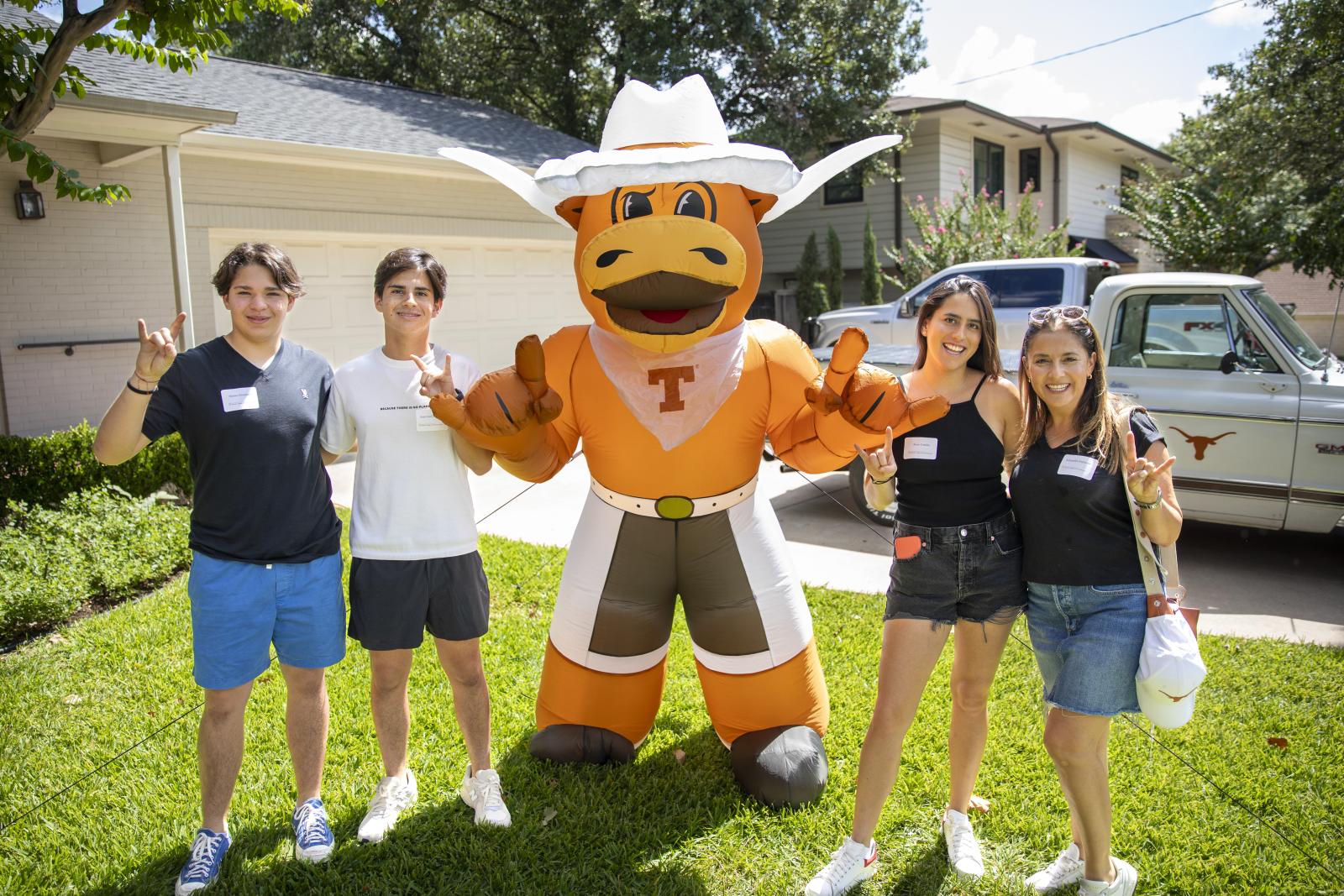 Students with blow up hook 'em in yard
