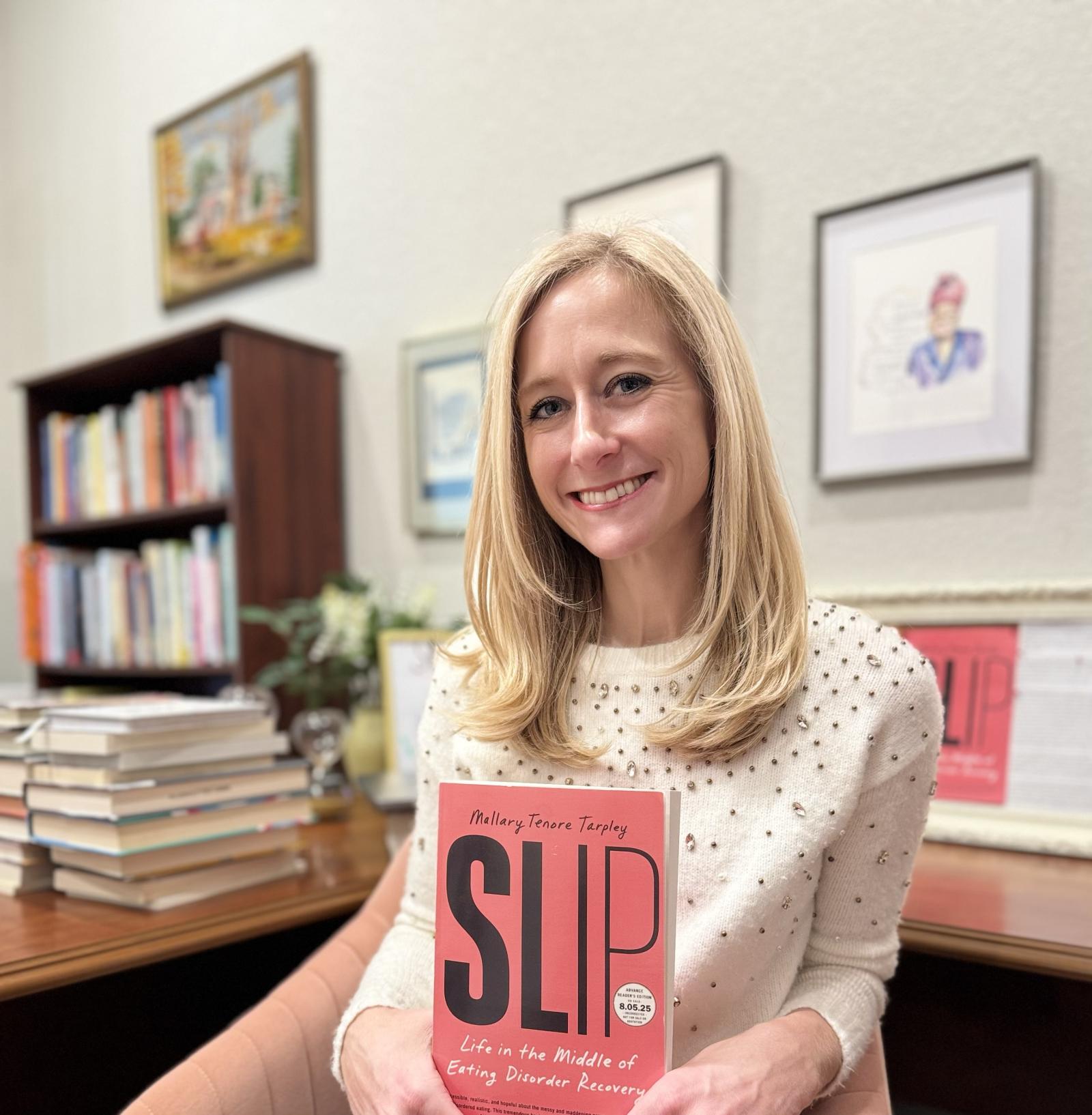 portrait of Mallary Tenore Tarpley with her book "SLIP"
