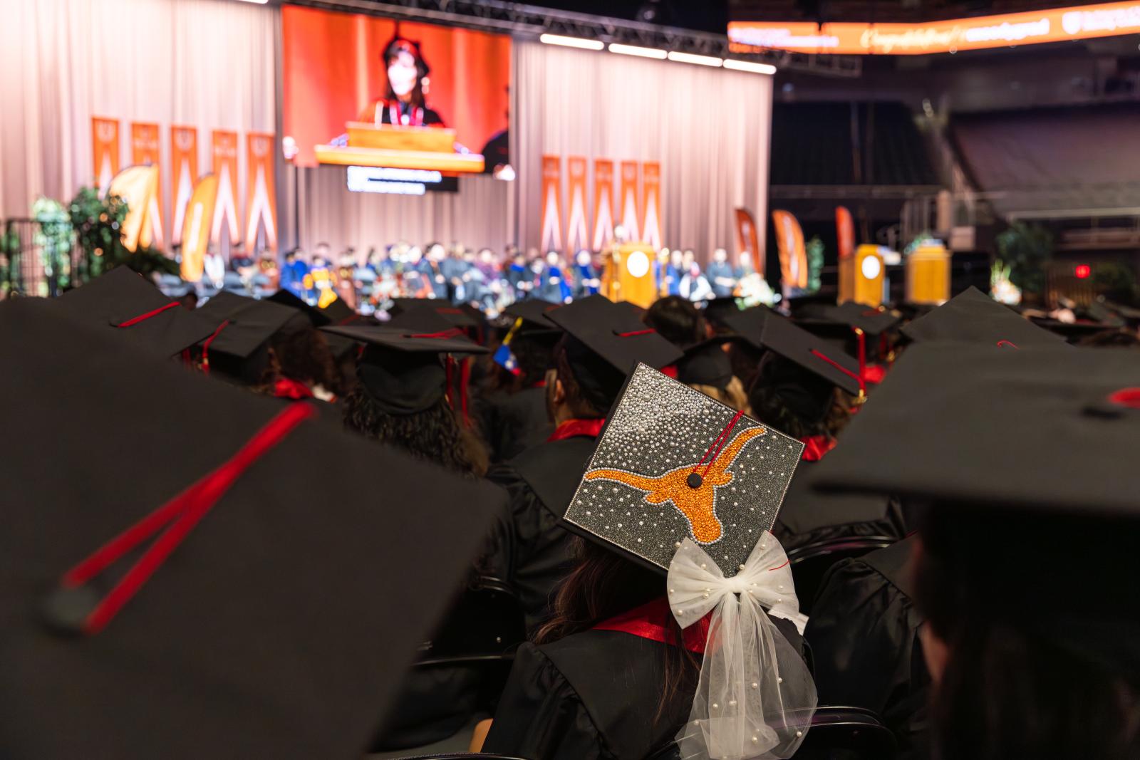 A graduation cap decorated with a Longhorn and bow
