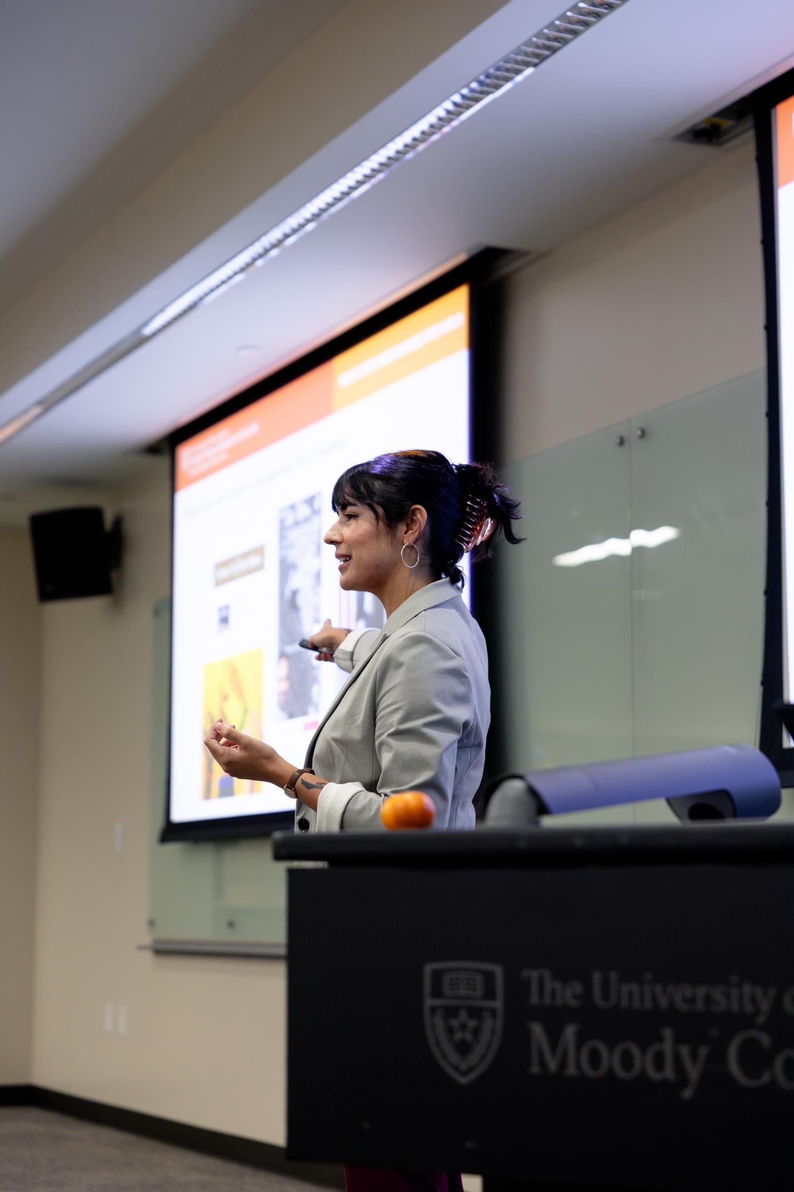 Eugenia Quintanilla speaking in front of a classroom