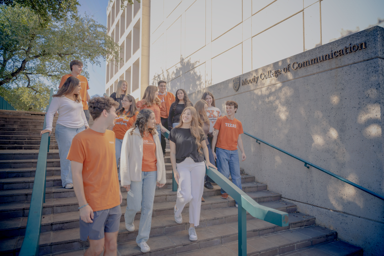 Students walking outside of moody college together collaborating