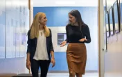 two people talking in hallway