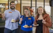 People eating cake at outside reception