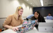two students working on a computer together