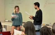 Two students act out a conflict resolution scene