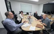 Faculty members discussing teaching topics in a conference room