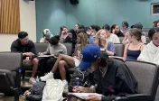 Students working in groups in a lecture hall